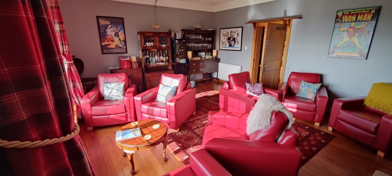 honesty bar with red leather tub chairs
